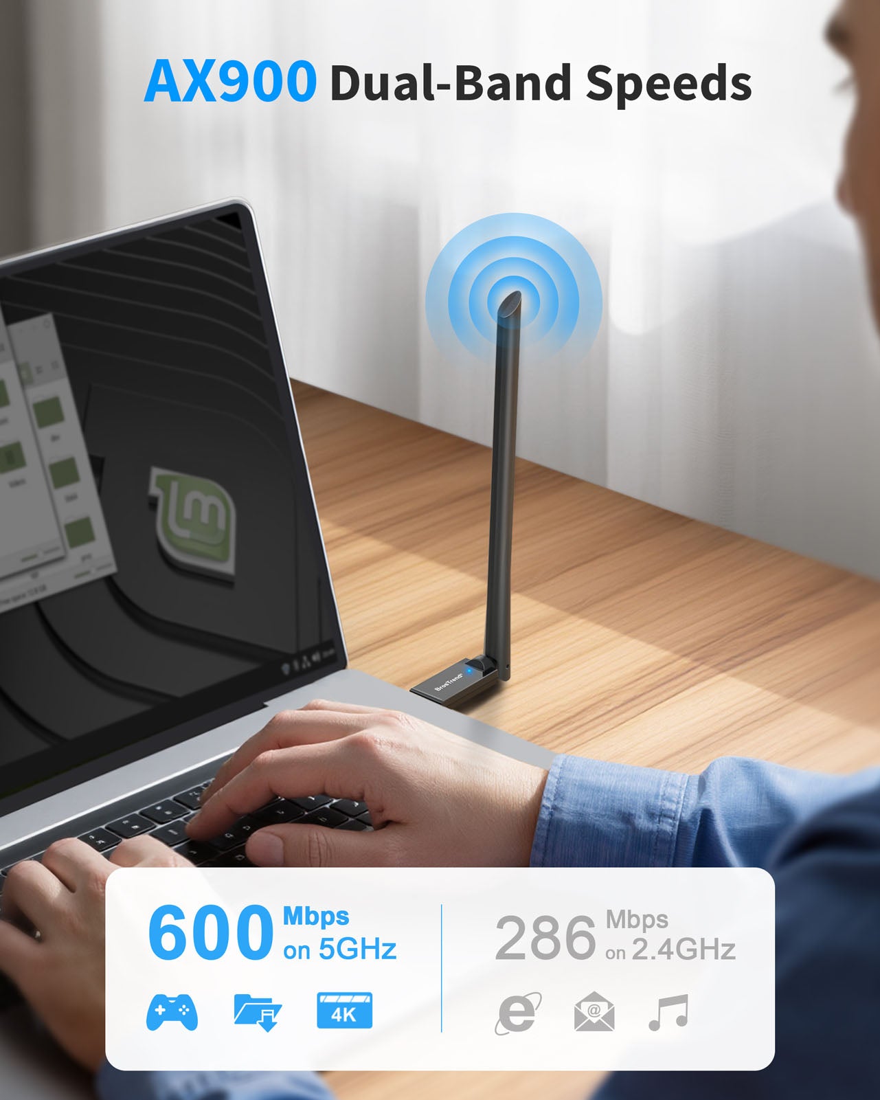 A Man Typing on a Laptop Computer with the AX900 Linux USB WiFi 6 Adapter Plugged in Delivering up to 600 Mbps on 5 GHz or 286 Mbps on 2.4 GHz Band Fast Wireless Speeds for Coding Streaming and Video Calls