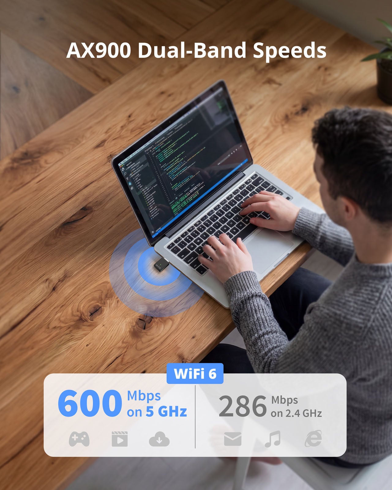 A Man Working with a Laptop Computer with the AX900 Mini USB WiFi 6 Adapter Plugged in Delivering up to 600 Mbps on 5 GHz or 286 Mbps on 2.4 GHz Band Fast Wireless Speeds for Coding Streaming and Video Calls
