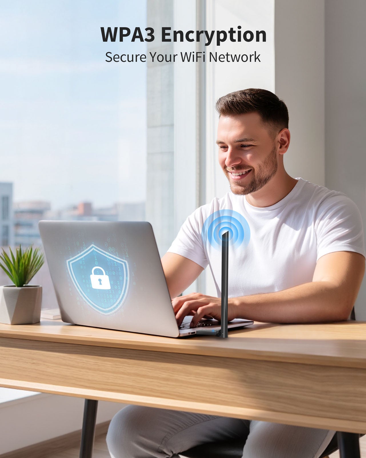 A Smiling Man Working on a Laptop with the AX900 USB WiFi 6 Adapter Plugged in It Secures Data and Privacy by Supporting WPA3 Encryption